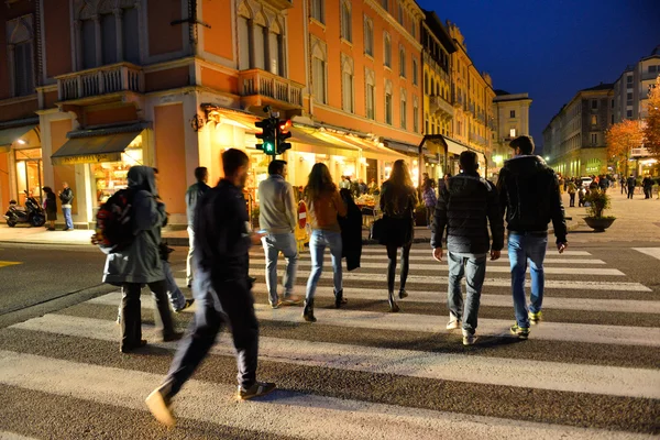 COMO, ITALY - NOVEMBER 16: Unidentified pedestrians at Como crossing on November 16, 2013 in Como, Italy. The famous scramble crosswalk near the Como lake.