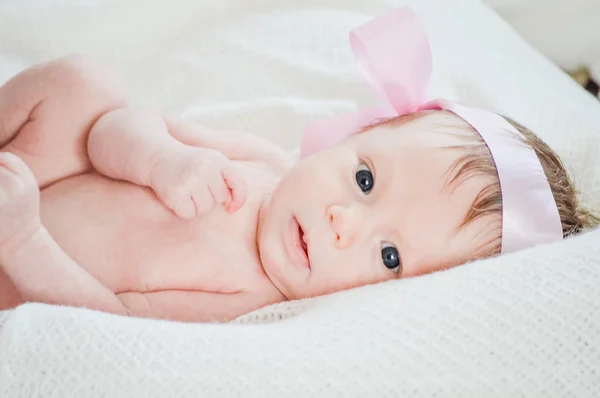 Cute little baby girl on white blanket staring up — Stock Photo #22922084
