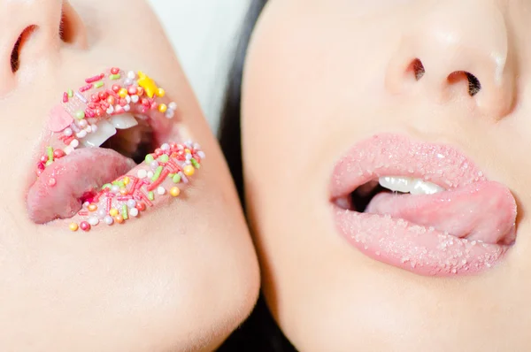 Closeup on two female sweet candy lips with licking tongue