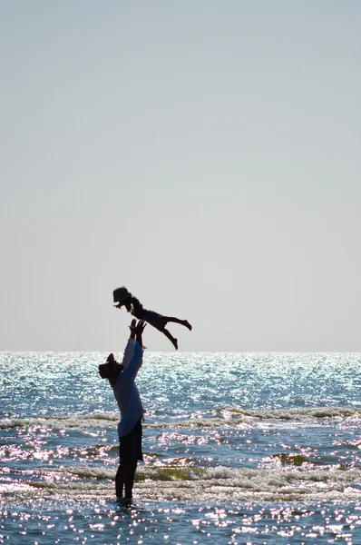 Happy father and son on seashore beach having fun