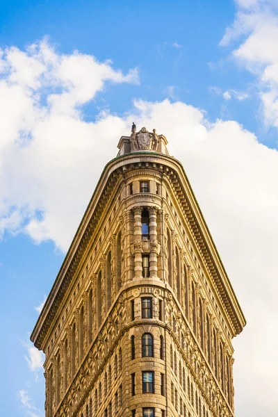 Facade of the Flatiron building with iron statue of Man on the