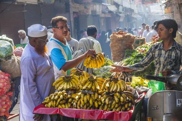 Man sells bananas at the old vegetable street market in Delhi