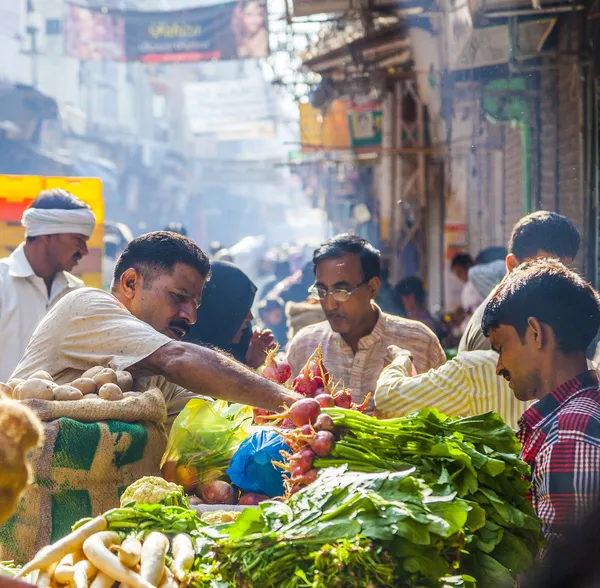 Man sells bananas at the old vegetable street market in Delhi