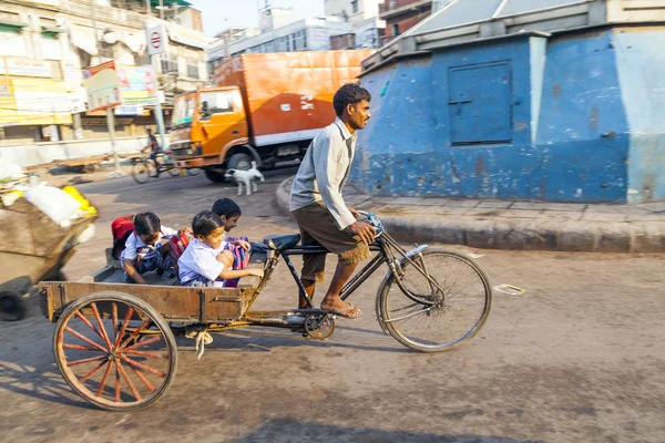 Father transports his children in a cycle rickshaw