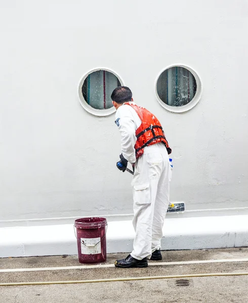 Worker renovate the ship's side