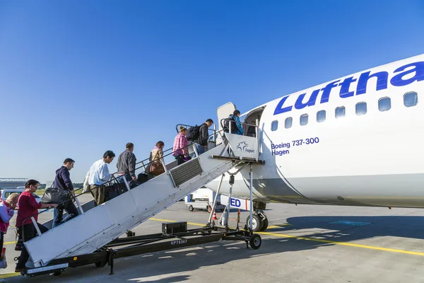 People board the Lufthansa aircraft
