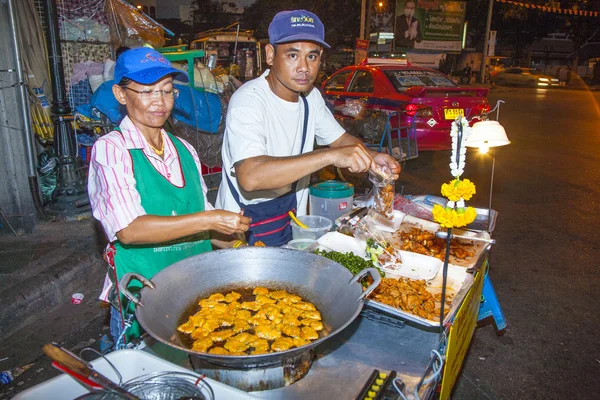 Chef cooks food at a street-side restaurant