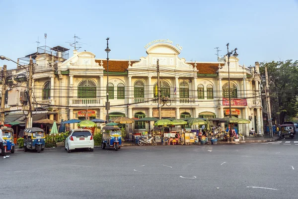 Historic building in Bangkok with street market in front