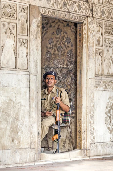 Policeman pays attention in the Red Fort to protects visitors fr