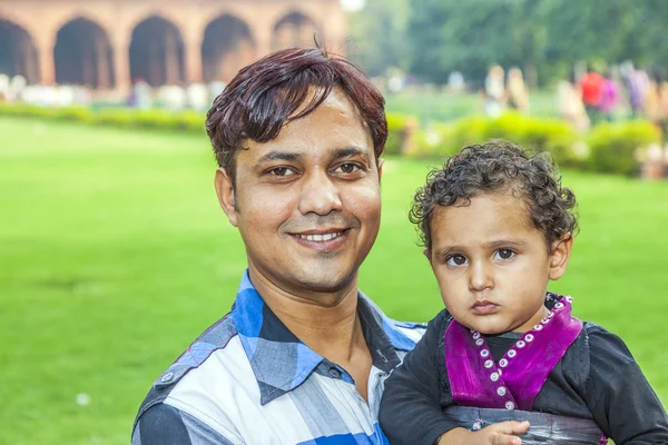 Indian man poses with his child