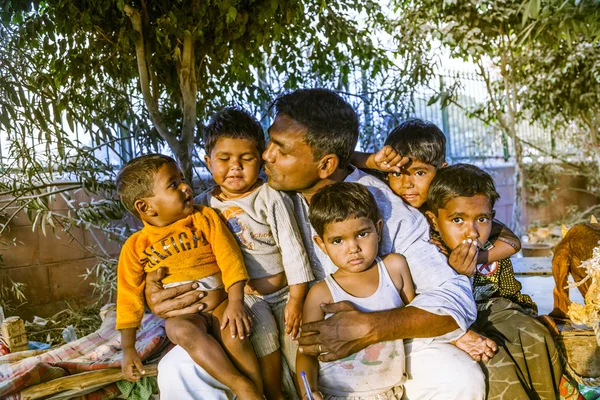 Proud father poses with his children at the bazaar