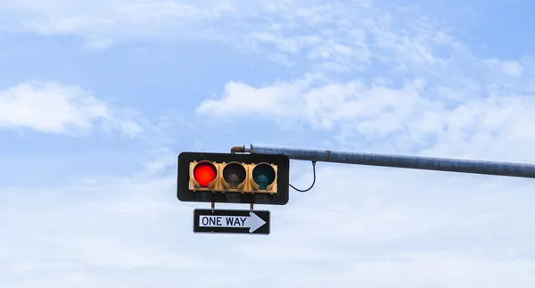 Red traffic light with one way sign