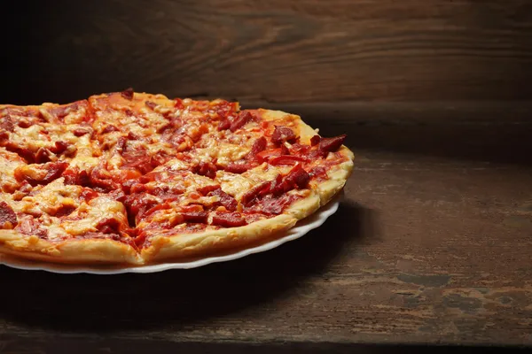 Round pizza on wood background