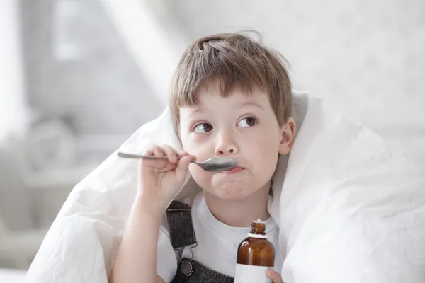 Boy drinking cough syrup