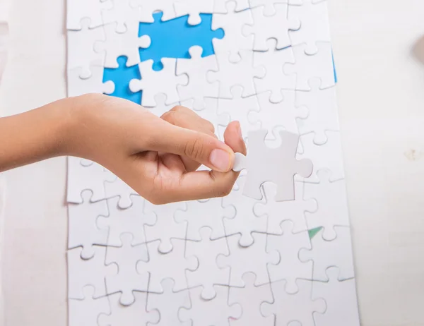 Girl Hand Playing Jigsaw Puzzle