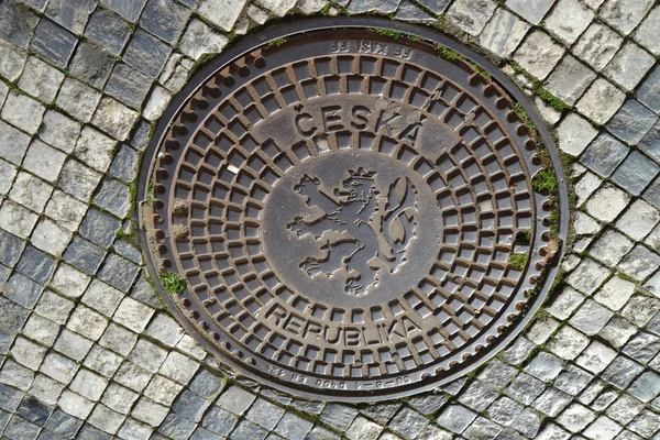 Hatch cover in Prague with the coat of arms of the Czech republi