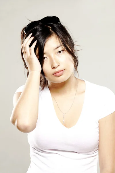 Beautiful asian woman with head ache