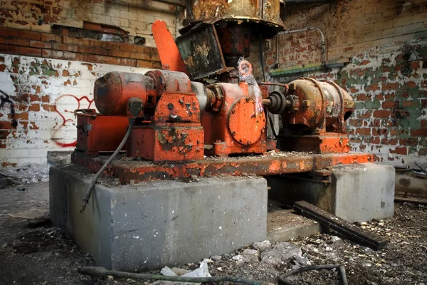 Orange machine inside abandoned building