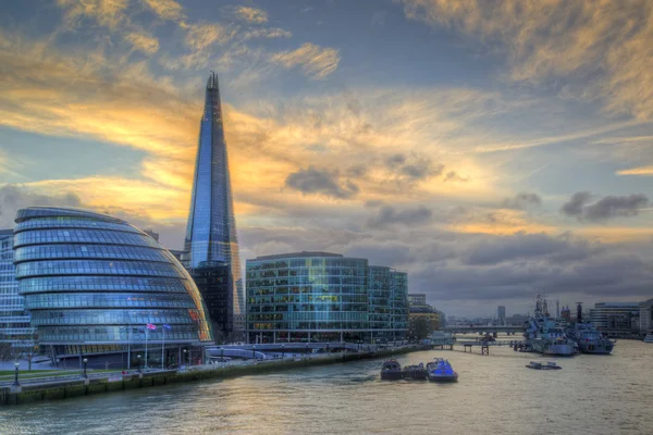 London City skyline along River Thames during vibrant sunset
