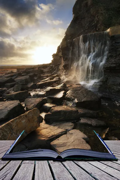 Book concept Beautiful landscape image waterfall flowing into ro