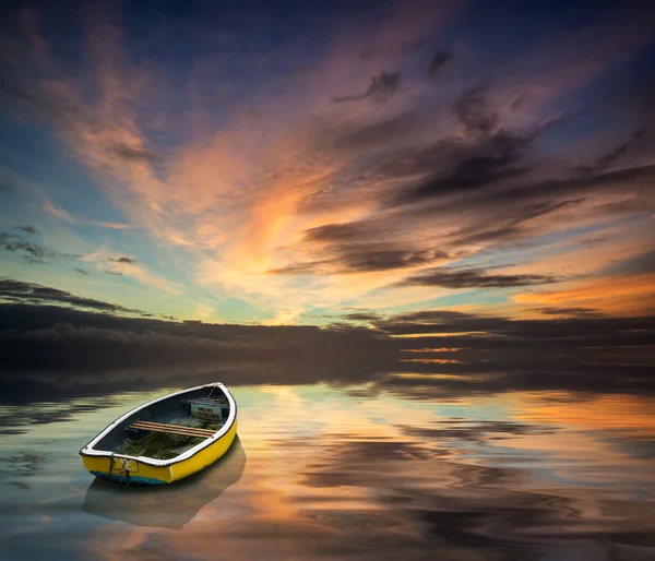 Beautiful vibrant blue and pink Winter sky with single boat floa