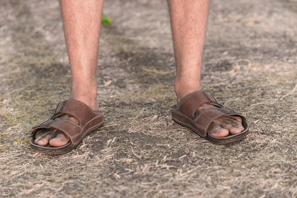 Feet of a sad farmer without crop