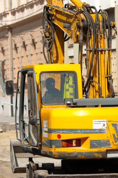 Big excavator at urban construction site