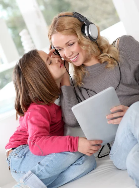 Mother and daughter listening to music — Stock Photo #13932655