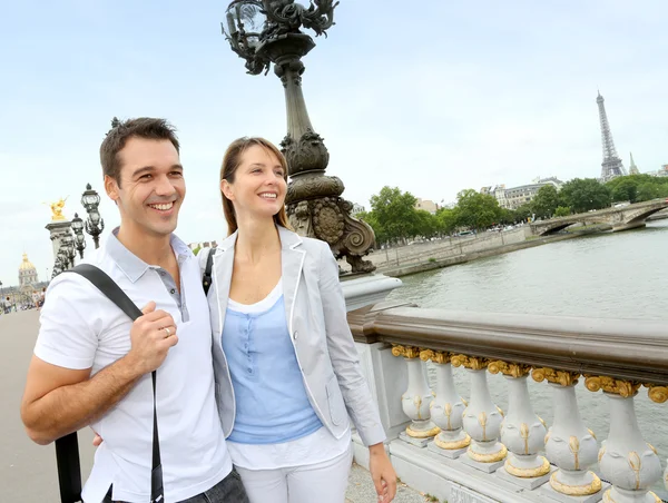 Couple in Paris walking on the bridge Alexander the Third