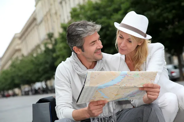 Middle aged couple looking at city map