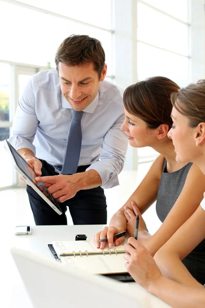 Manager presenting business plan with electronic tablet