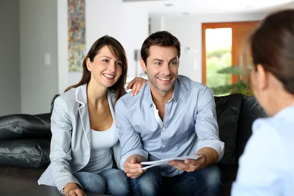 Couple meeting architect for plans of future home