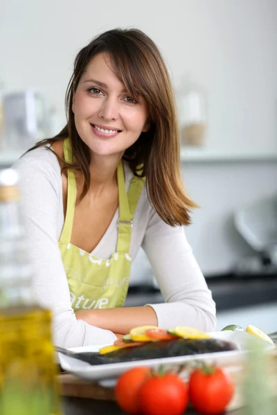 Smiling brunette woman in home kitchen
