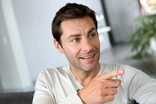 Portrait of man showing something with finger — Stock Photo #13962308