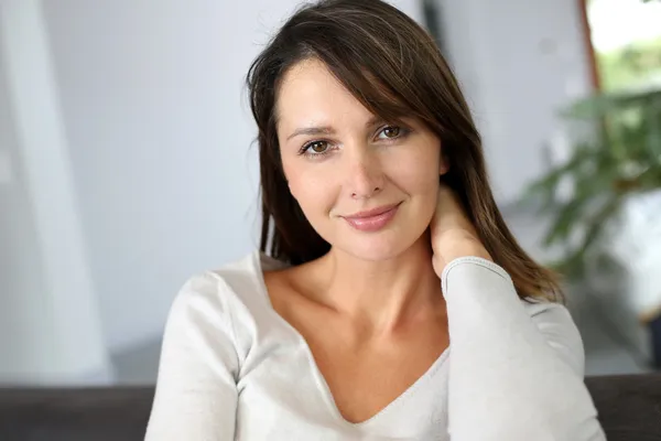 Portrait of attractive brunette woman looking at camera