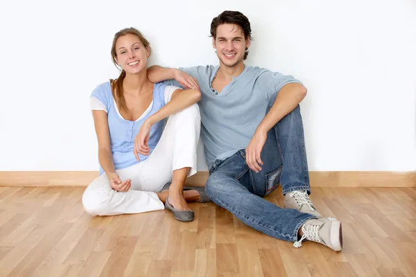 Couple sitting on the floor in new apartment