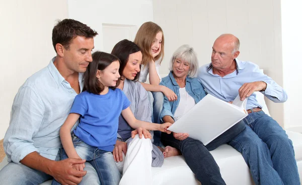 3-generation family looking at photo album