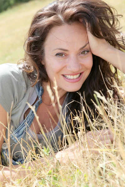 Beautiful woman laying down in meadow