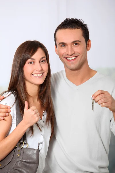 Happy couple holding keys of their new home