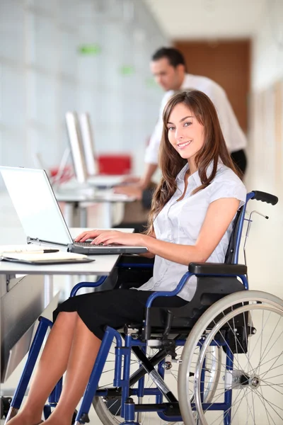 Businesswoman in wheelchair working in the office