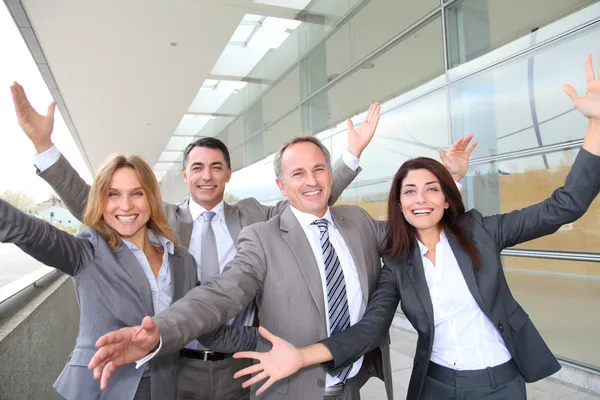 Group of happy business with arms up