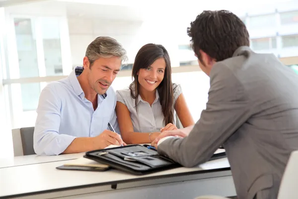 Father and teenager signing loan contract