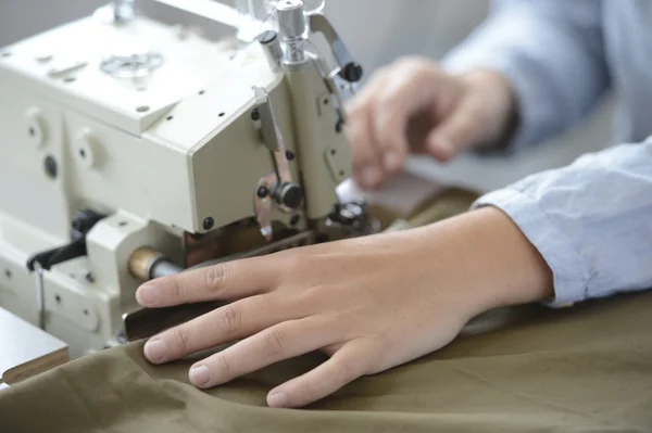 Dressmaker hand using sewing machine