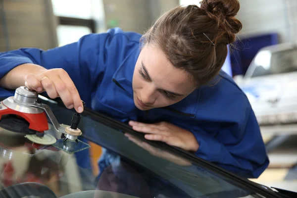 Student changing car windshield