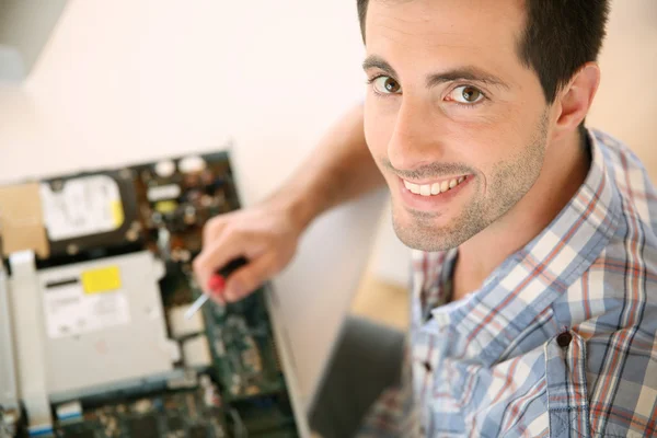 Man fixing electronic appliance