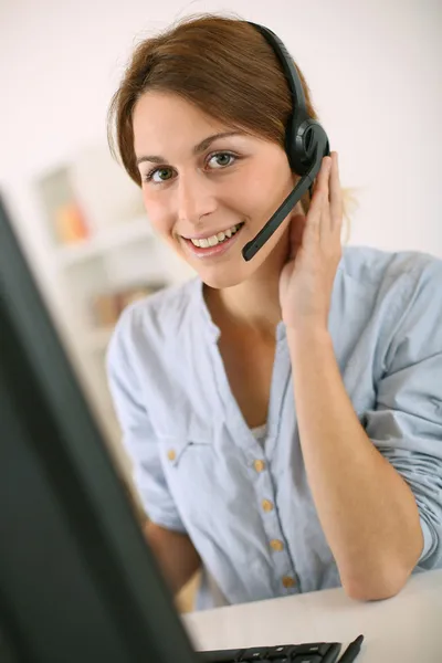 Woman at work talking on phone with headset