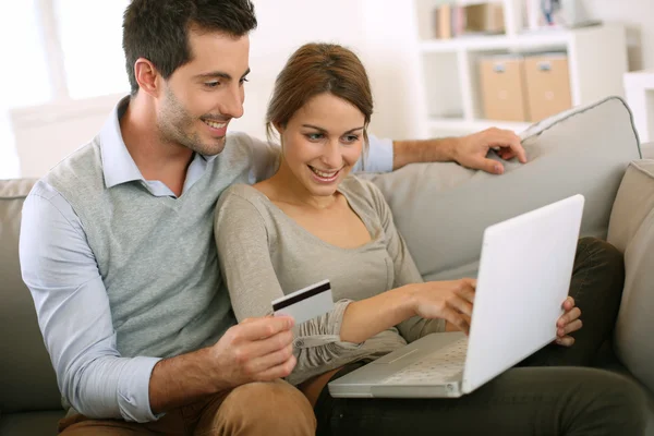 Couple using credit card to shop on internet