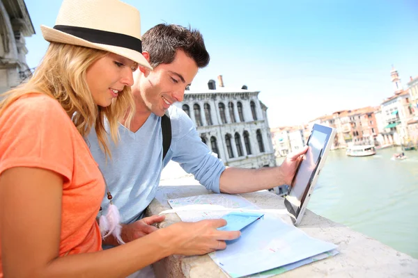 Tourists using digital tablet on the Rialto bridge