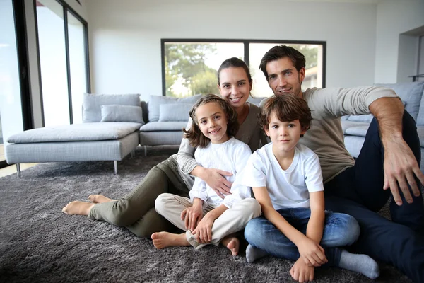 Family sitting on carpet