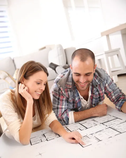 Couple looking at construction house plan